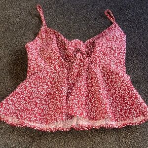 Spaghetti string shirt, perfect for the summer with a. bow tie in the front.